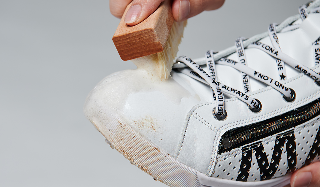 Scrub sneakers to create a foaming action.